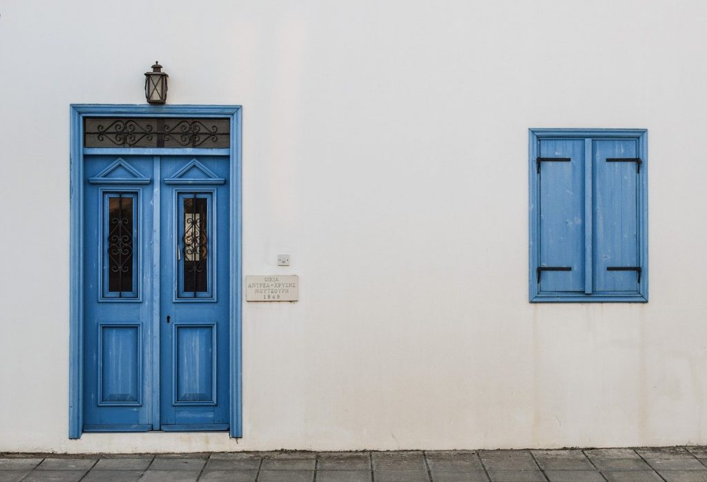 mur blanc de maison avec porte bleu